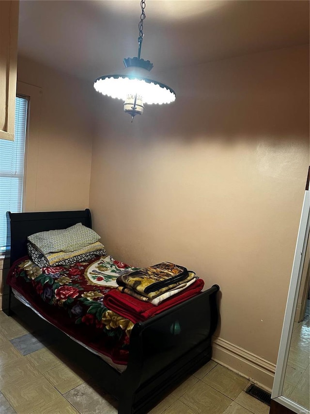 bedroom with visible vents and baseboards