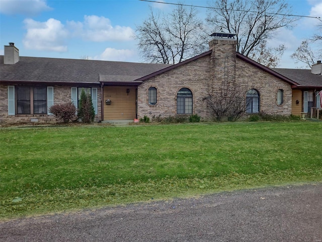 ranch-style home with a front lawn