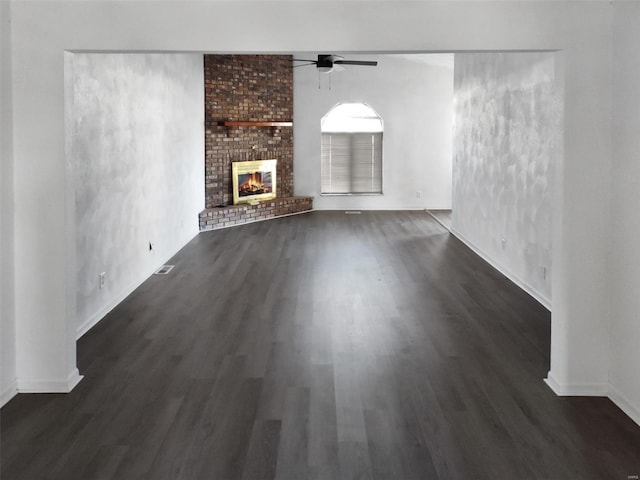 unfurnished living room with ceiling fan, dark hardwood / wood-style flooring, and a fireplace