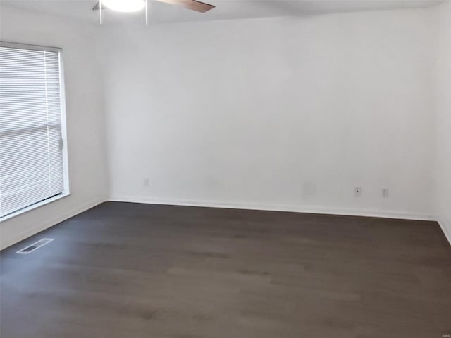 unfurnished room with dark hardwood / wood-style floors and ceiling fan