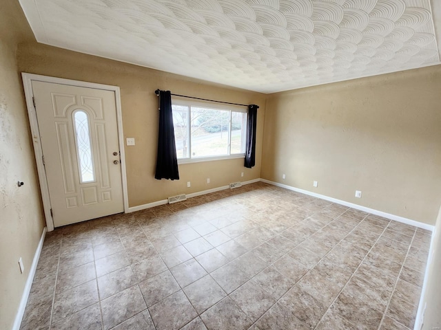 foyer entrance with light tile patterned floors