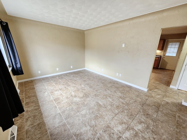 spare room with a textured ceiling