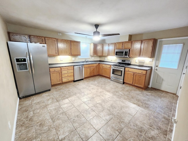 kitchen with stainless steel appliances, ceiling fan, and sink