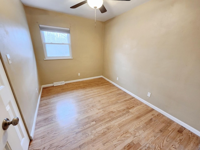 spare room with light wood-type flooring and ceiling fan