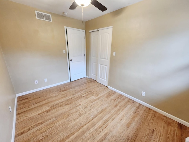 unfurnished bedroom featuring a closet, ceiling fan, and light hardwood / wood-style flooring