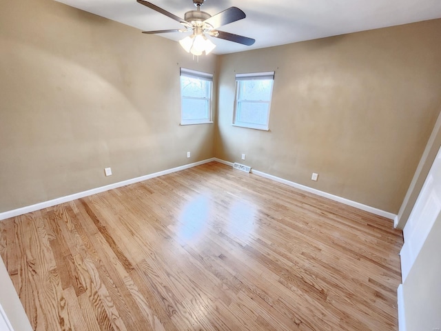 empty room featuring light wood-type flooring and ceiling fan