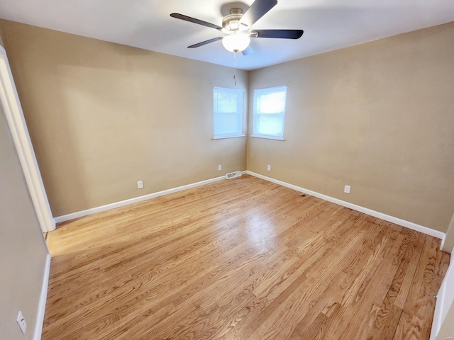 empty room with ceiling fan and light hardwood / wood-style floors