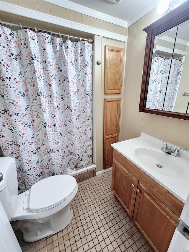 bathroom with tile patterned floors, walk in shower, ornamental molding, vanity, and toilet