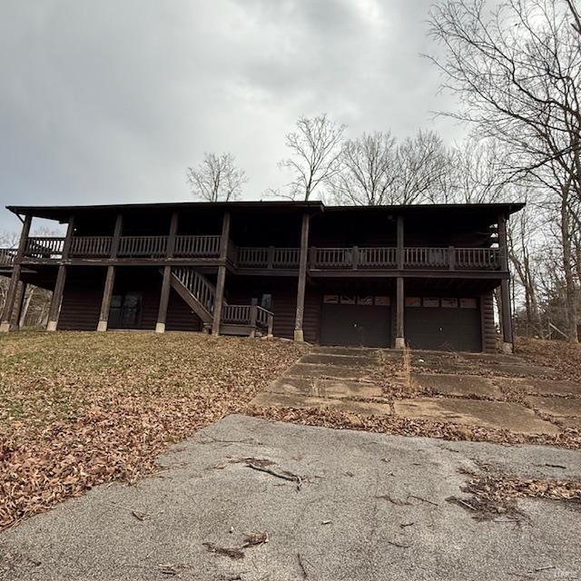 view of front facade with a garage and a wooden deck