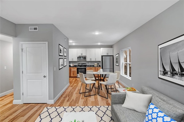 living room with light hardwood / wood-style flooring