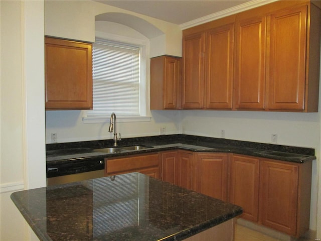 kitchen featuring dishwasher, ornamental molding, dark stone counters, and sink