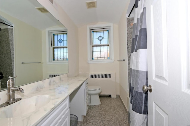 bathroom with toilet, radiator, walk in shower, and vanity