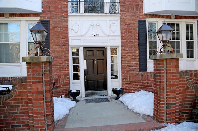 view of snow covered property entrance