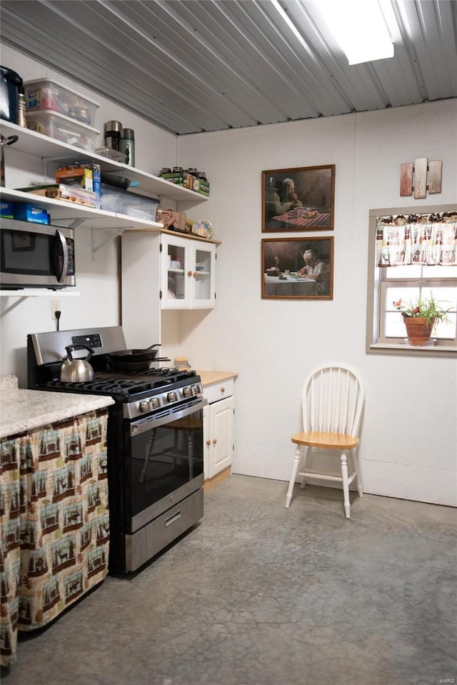 kitchen with white cabinets and appliances with stainless steel finishes