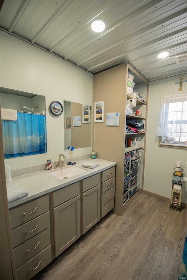 bathroom featuring vanity, wood-type flooring, and wooden ceiling