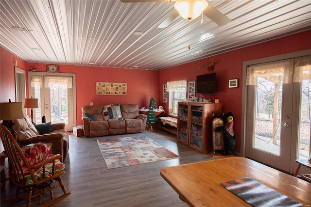 living room featuring wood-type flooring and ceiling fan