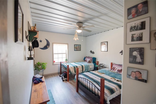 bedroom with ceiling fan and light hardwood / wood-style flooring