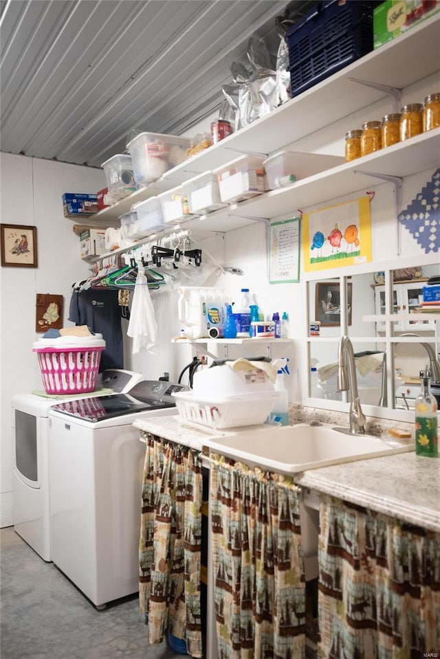 clothes washing area with separate washer and dryer and sink