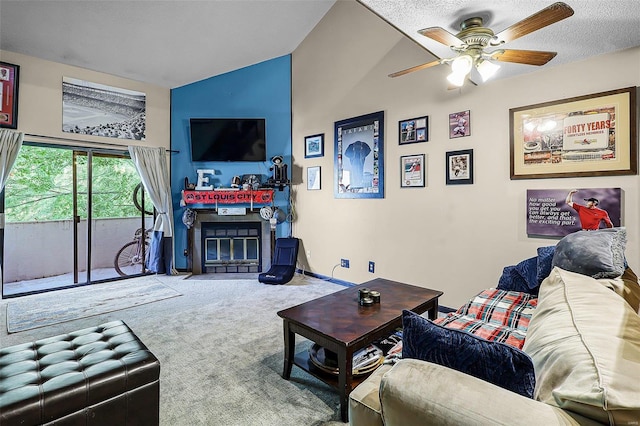 living room featuring ceiling fan, a textured ceiling, and carpet flooring