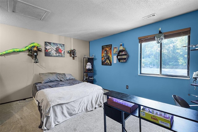 bedroom with a textured ceiling and carpet