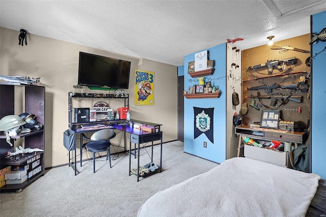 carpeted bedroom with a textured ceiling and a workshop area