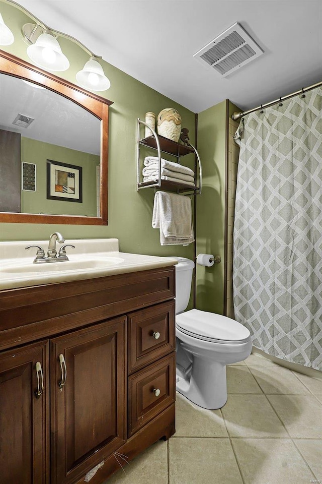 bathroom with toilet, vanity, tile patterned flooring, and curtained shower