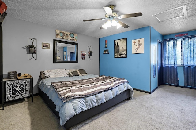 carpeted bedroom with a textured ceiling and ceiling fan