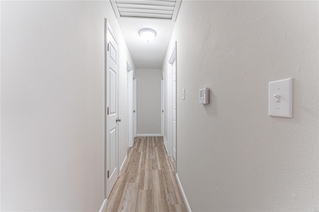 corridor with light hardwood / wood-style flooring