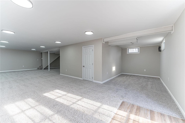 basement featuring light carpet