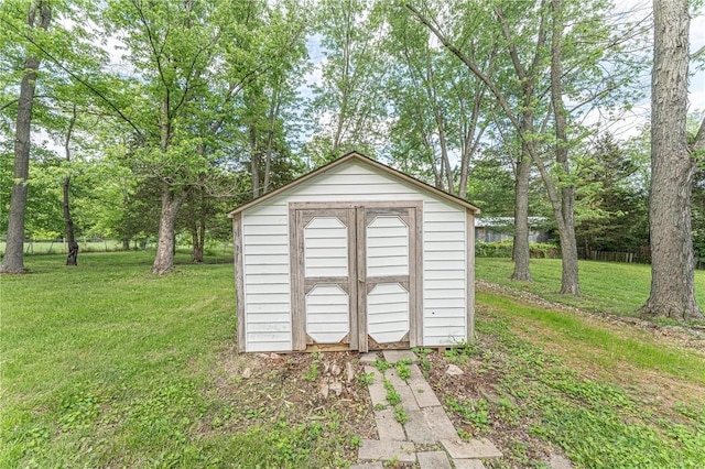 view of outdoor structure featuring a lawn