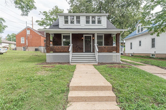 bungalow with a porch and a front lawn