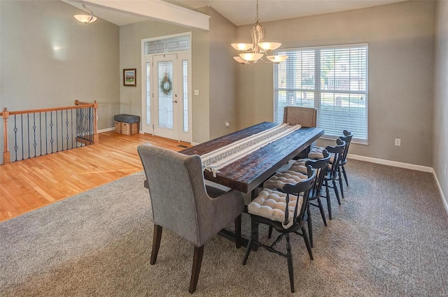 dining area featuring hardwood / wood-style flooring and a chandelier