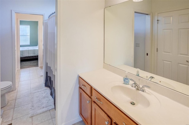 bathroom featuring toilet, vanity, and tile patterned floors