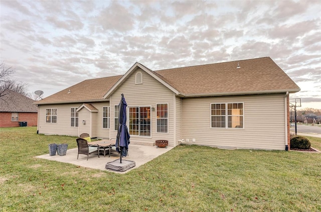 rear view of house featuring a patio area and a lawn