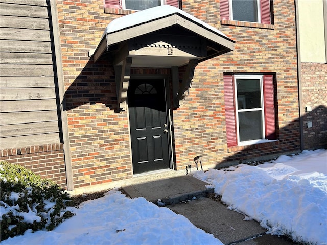 view of snow covered property entrance