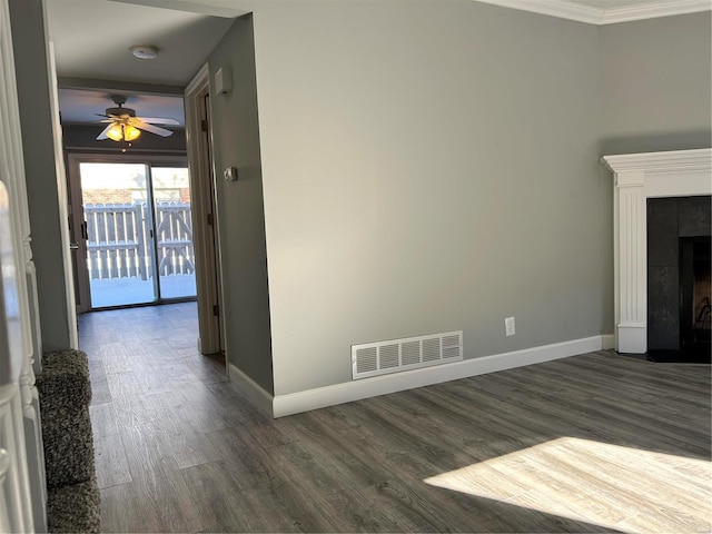 unfurnished living room with ceiling fan, dark hardwood / wood-style flooring, ornamental molding, and a fireplace