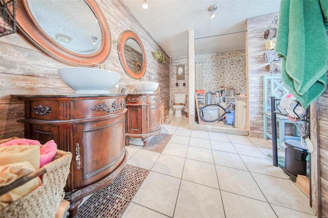 bathroom featuring tile patterned floors, toilet, vanity, and a textured ceiling