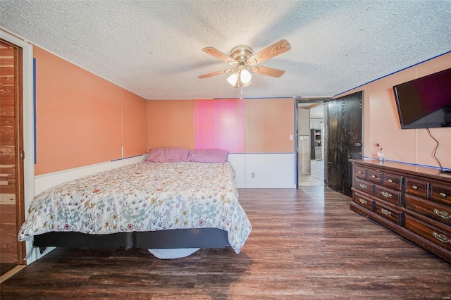 bedroom featuring a textured ceiling, ceiling fan, and wood-type flooring