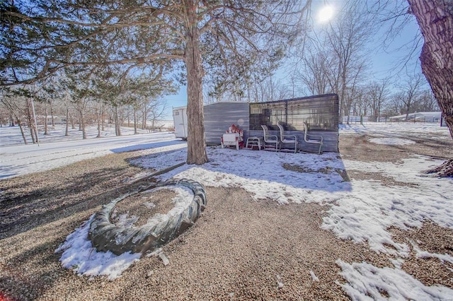 snowy yard with an outdoor structure