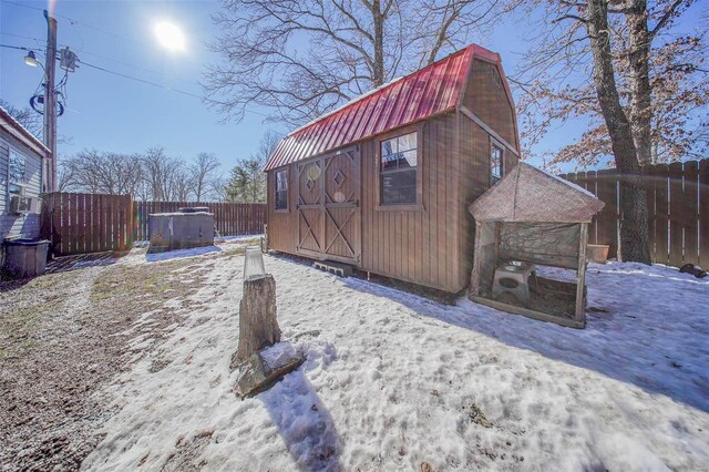 snow covered structure featuring a hot tub