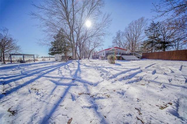 snowy yard featuring a pergola