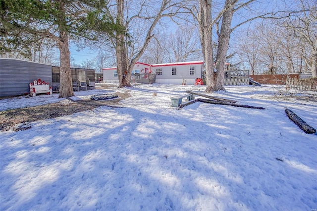 yard layered in snow featuring a wooden deck