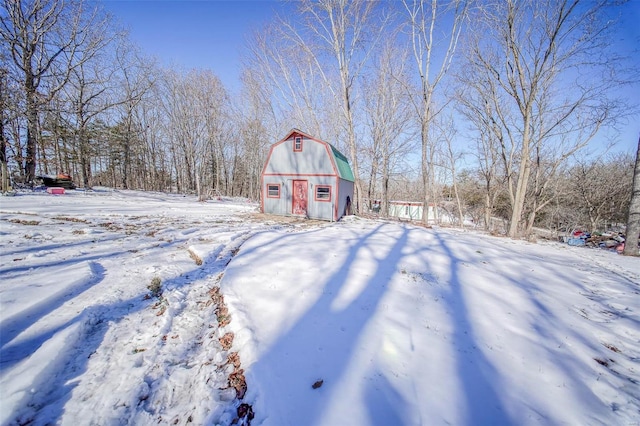 snowy yard with an outbuilding