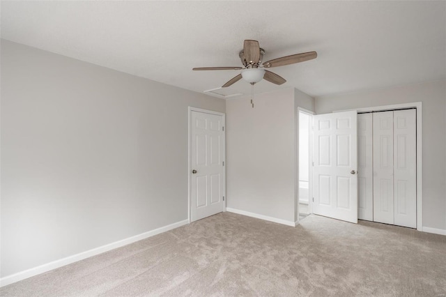 unfurnished bedroom with ceiling fan, light colored carpet, and a closet