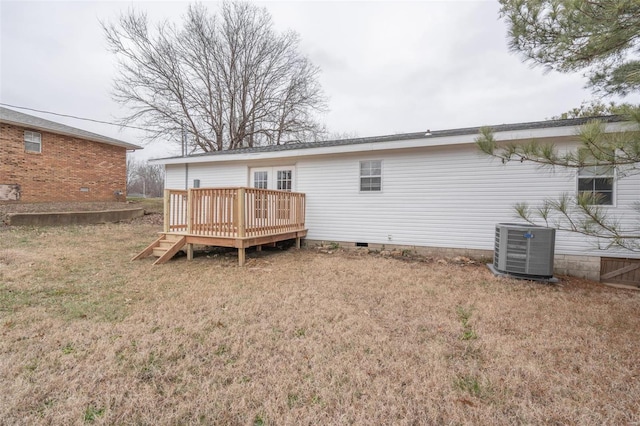 back of property featuring cooling unit, a lawn, and a wooden deck