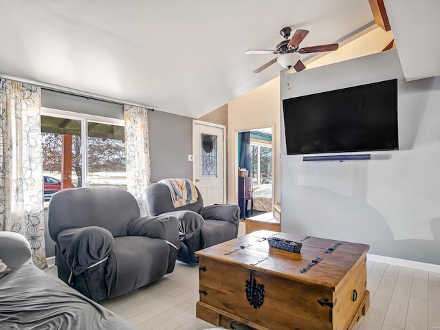 living room with lofted ceiling, ceiling fan, and light hardwood / wood-style flooring