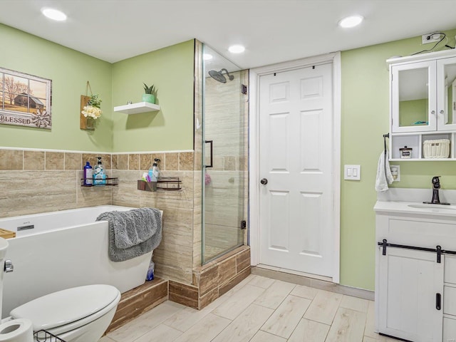 bathroom with vanity, toilet, and a shower with shower door