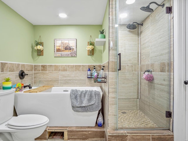 bathroom with walk in shower, toilet, and tile walls