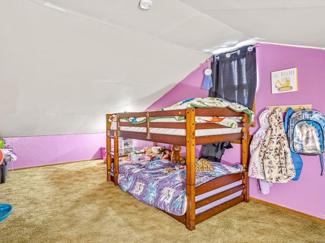 carpeted bedroom with vaulted ceiling