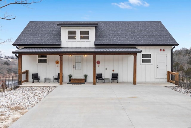 view of front of property with covered porch and a patio